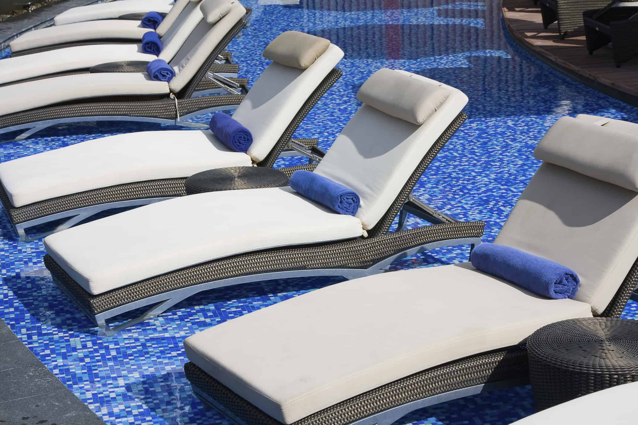 Row of lounge chairs in a pool