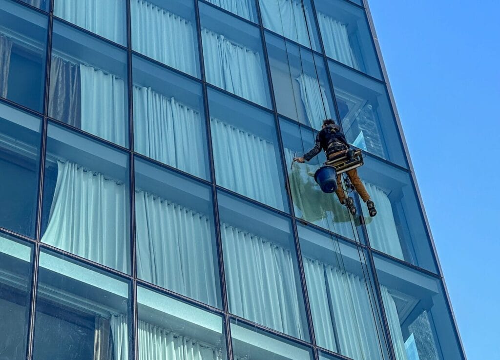 Window cleaning team on the exterior of a high-rise hotel.